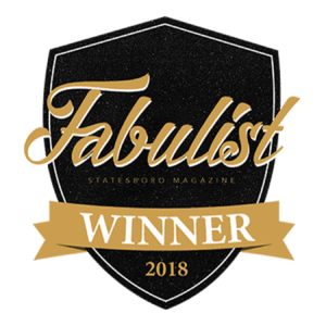 A black shield with gold & white writing for the 2018 Fabulist Magazine Winner emblem is displayed.