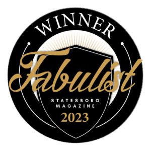 A black circle with gold & white writing for the 2023 Fabulist Magazine Winner emblem is displayed.